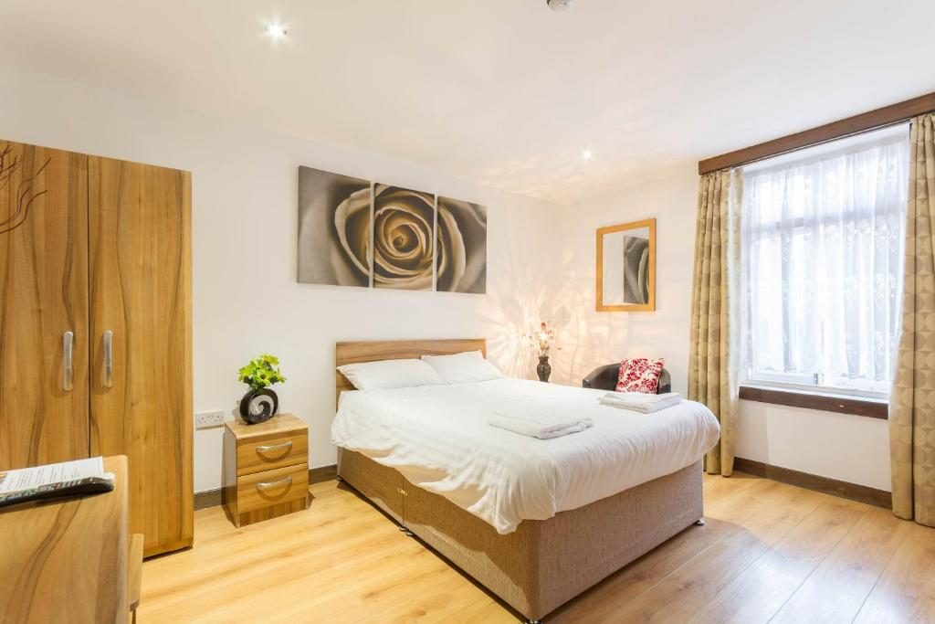 Double room at Brick Lane Hotel with wardrobe, window and oak floor